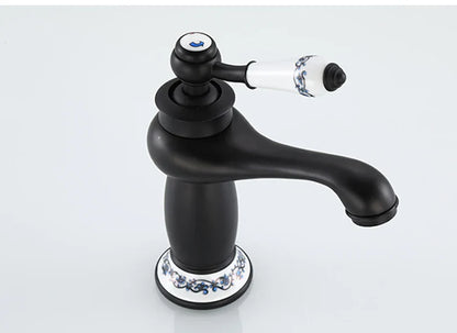 DecorBites™ antique bronze single handle bathroom faucet with black matte finish and white ceramic base with blue floral real shot details