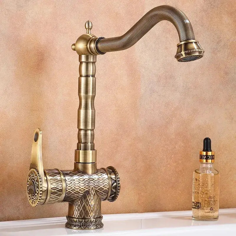 Decorbites antique bronze bathroom sink faucet with antique brass finish and ornate diamond patterned base and handle