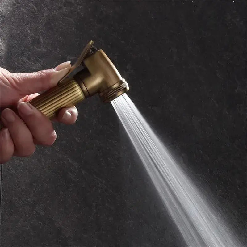 Brass-colored antique bronze bidet sprayer set handheld showerhead with textured grip and adjustable spray nozzle