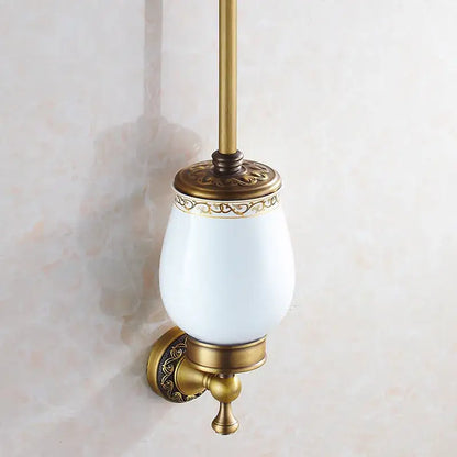 DecorBites™ antique bronze brass toilet brush holder with white ceramic bowl and ornate gold detailing for bathroom use