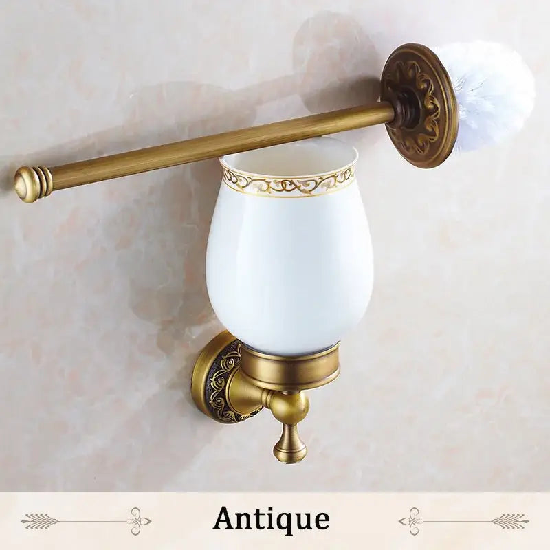 DecorBites antique bronze brass toilet brush holder with white ceramic cup and gold ornate detailing for bathroom use
