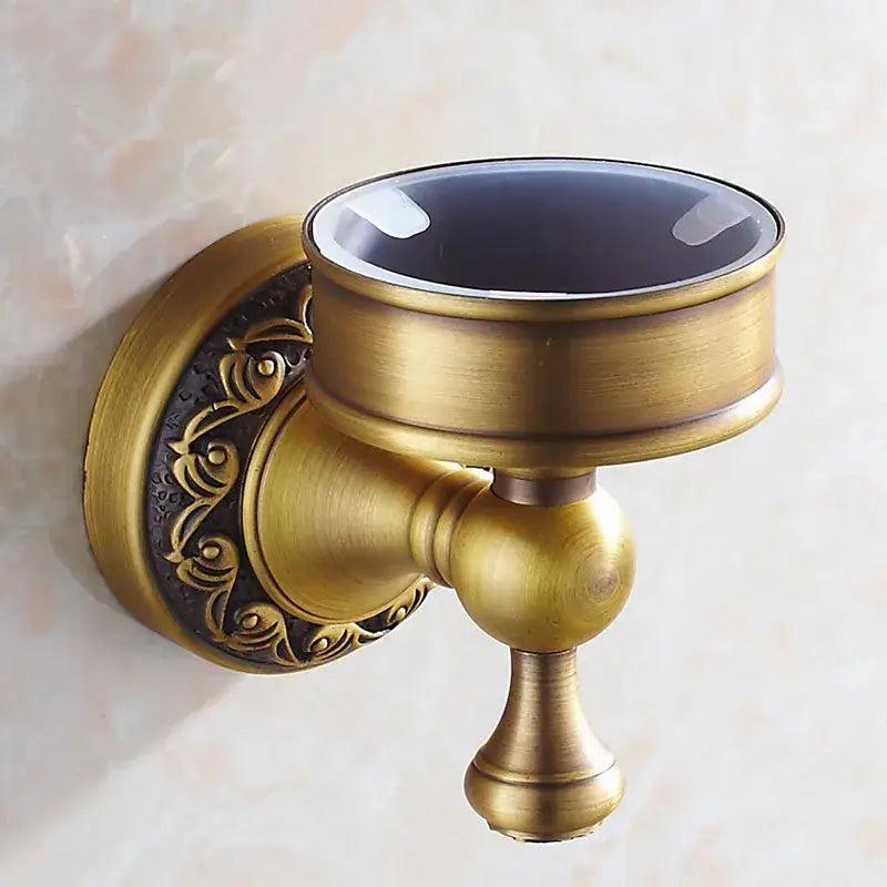 Antique bronze brass toilet brush holder with ornate scrollwork and dark glossy glass top for bathroom accessories