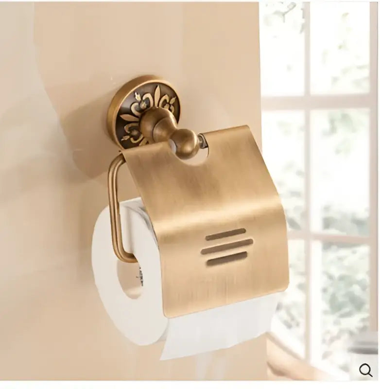 Decorbites antique brass toilet paper holder with ornate floral design and curved cover in bathroom accessories set