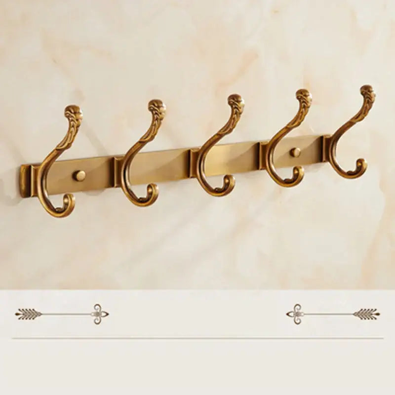 Gold-colored ornate wall-mounted robe hook with five decorative hooks in antique bronze carved style for bathroom and kitchen