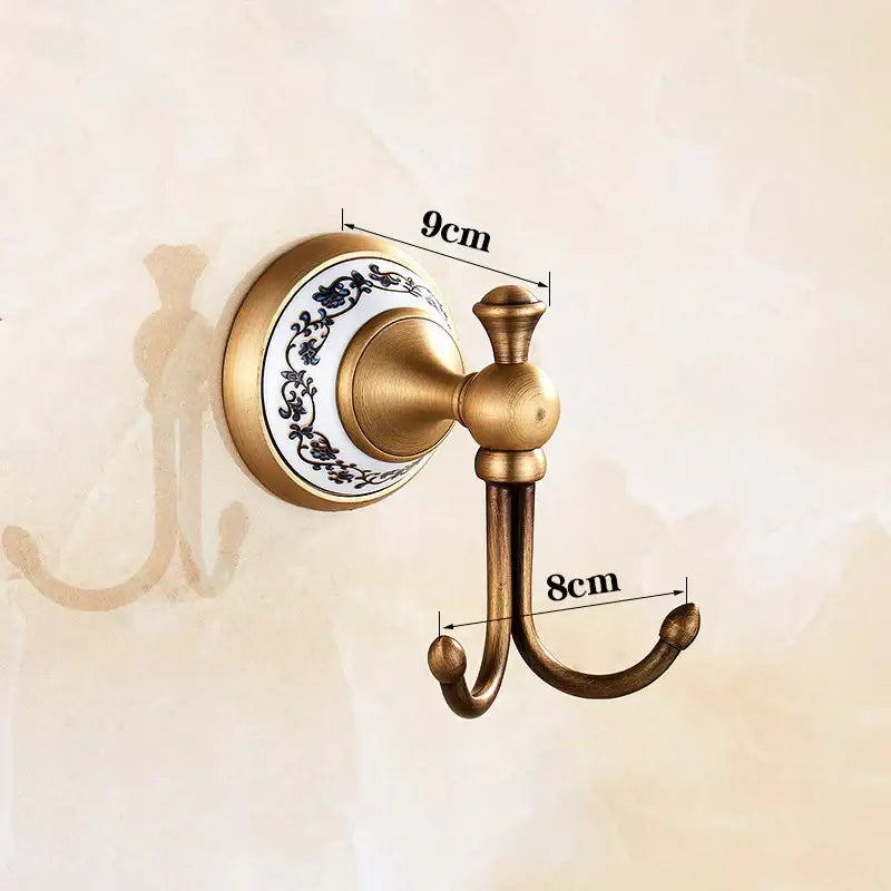 Decorbites antique bronze ceramic robe hook with decorative white ceramic backplate and black floral patterns