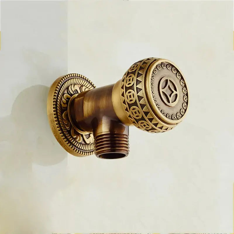 Antique bronze douche bidet sprayer set with ornate brass faucet and circular handle featuring geometric motifs