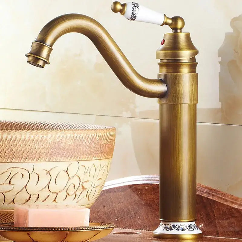 Antique bronze finish bathroom sink faucet by decorbites with single-handle and white ceramic handle with black floral detailing