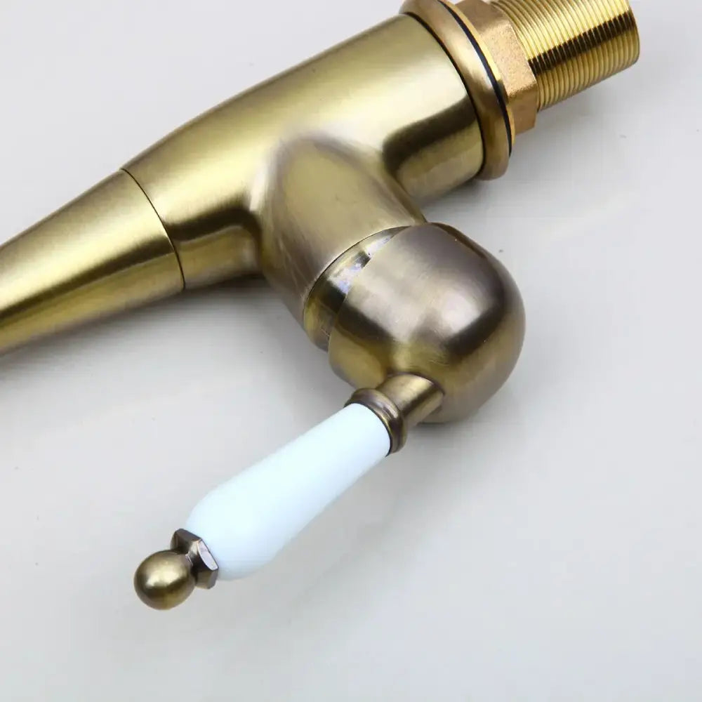 DecorBites antique bronze kitchen faucet with white ceramic handle and ornate detailing swivel spout 360 rotation