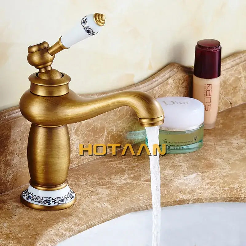 DecorBites antique bronze single handle basin faucet with brass finish white ceramic handle and black floral detailing