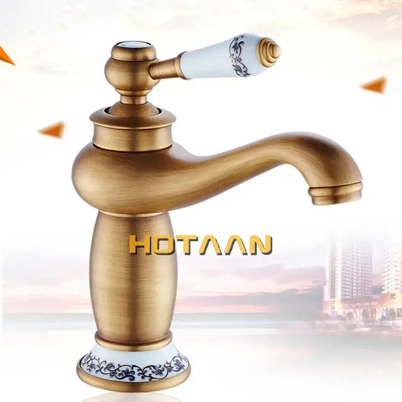 Decorbites™ antique bronze single handle basin faucet with antique brass finish and white ceramic handle with blue floral patterns
