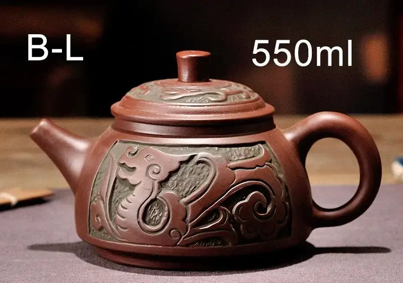 A rich reddish-brown antique bronze teapot set with carved dragon and cloud motifs in mine purple mud yixing clay