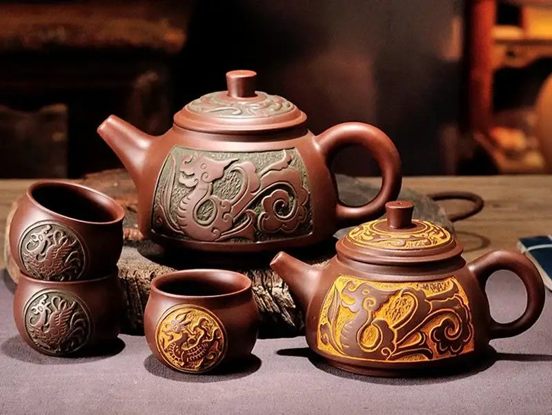 Brown ceramic antique bronze teapot with intricate dragon carvings and greenish gold panel from bronze teapot set
