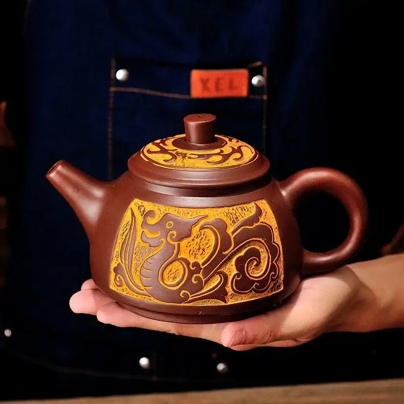 Brown clay antique bronze teapot set featuring intricate golden dragon and cloud motifs from decorbites mine purple mud yixing