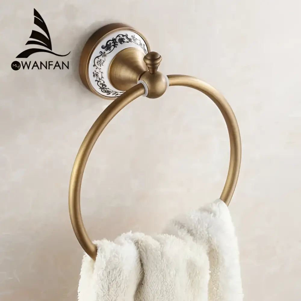 Antique bronze towel ring with solid brass construction and decorative ceramic plate featuring black floral patterns