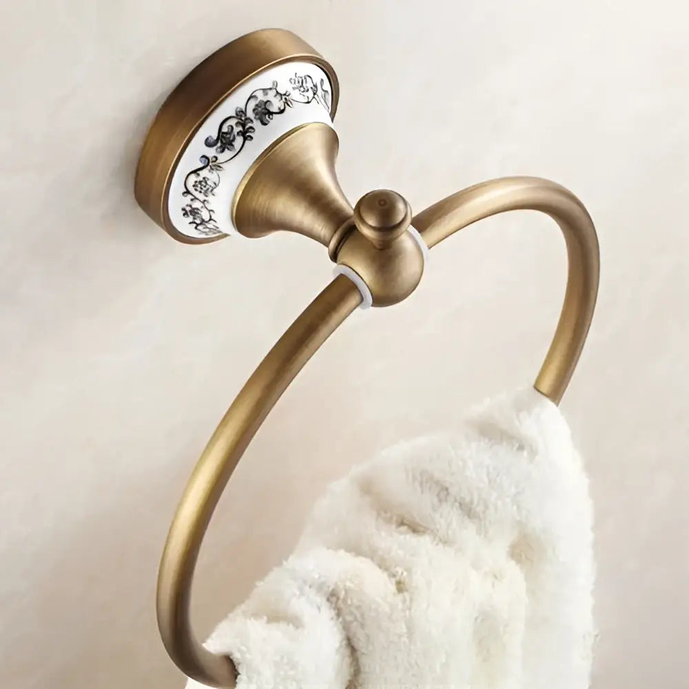 DecorBites™ antique bronze towel ring with decorative white ceramic plate and black floral patterns for bathroom use