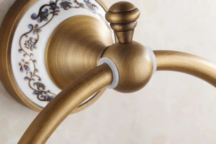 Decorbites antique bronze towel ring with antique brass finish and blue floral ceramic backplate for bathroom use