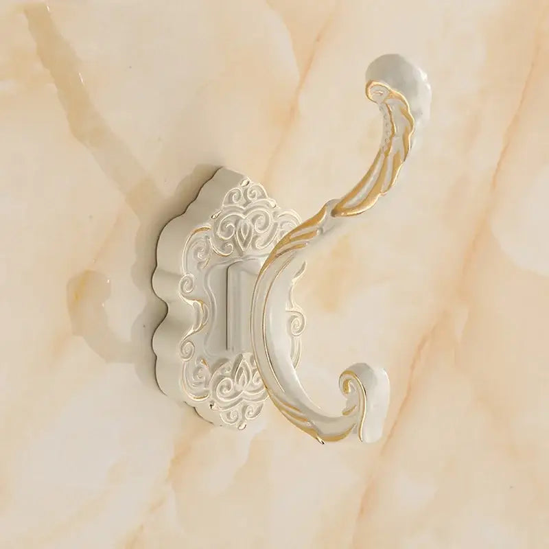 White and gold ornate wall hook with intricate scrollwork design for clothes towel coat in antique bronze wall hooks rack