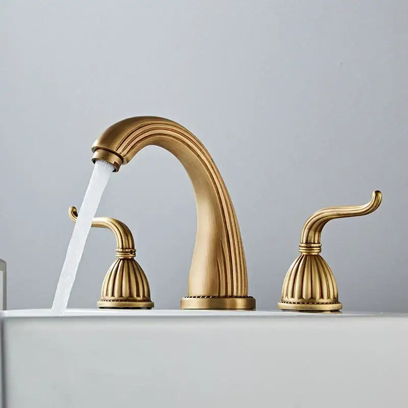 DecorBites™ antique bronze widespread basin faucet with three brass-finished ornate handles and curved spout