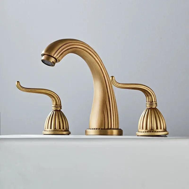 DecorBites™ antique bronze widespread basin faucet with three ornate brass-finished handles and fluted spout