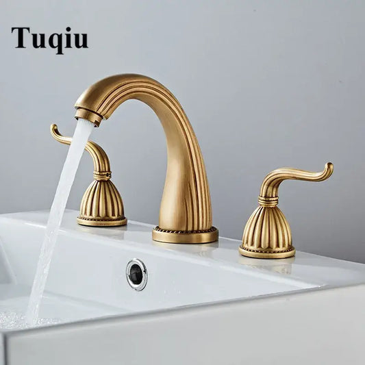 DecorBites antique bronze widespread basin faucet by Tuqiu with gold-toned fluted design and double handles