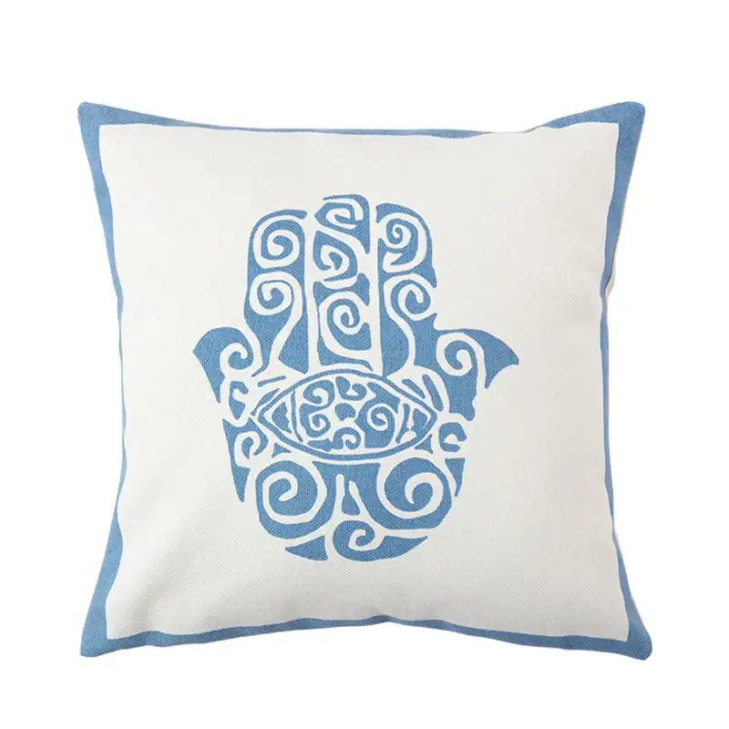 Decorbites™ pillow cover with white fabric base and blue embroidered hamsa design, complementing antique brown tiger print style