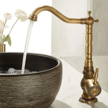 Decorbites antique carved brass bathroom sink faucet with ornate detailing and curved spout hot and cold mixer