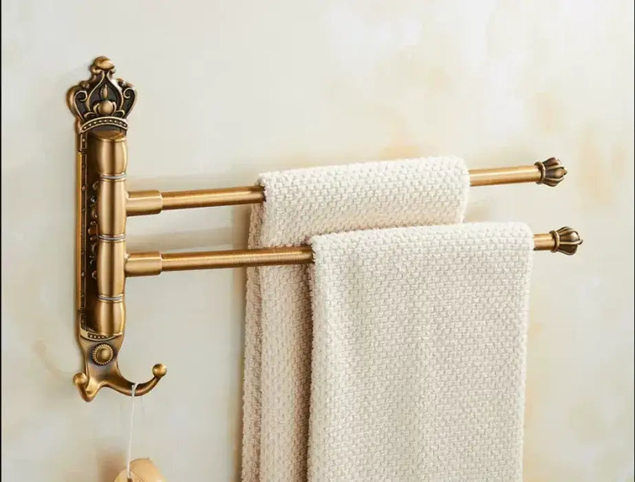 Decorbites antique carved swivel towel rack in brass with crown design and two rotating bars holding textured towels