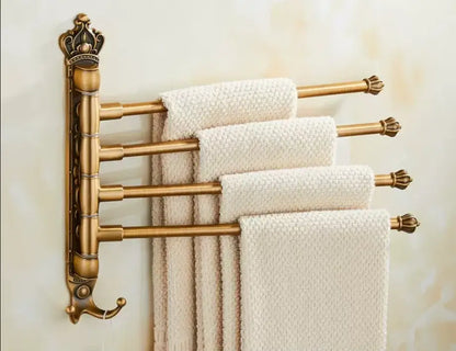 Antique carved swivel brass towel rack by decorbites holds four cream textured towels with ornate crown scrollwork design