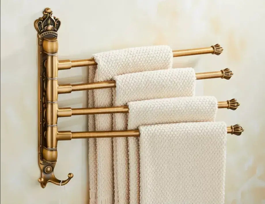 Antique carved swivel brass towel rack by decorbites holds four cream textured towels with ornate crown scrollwork design