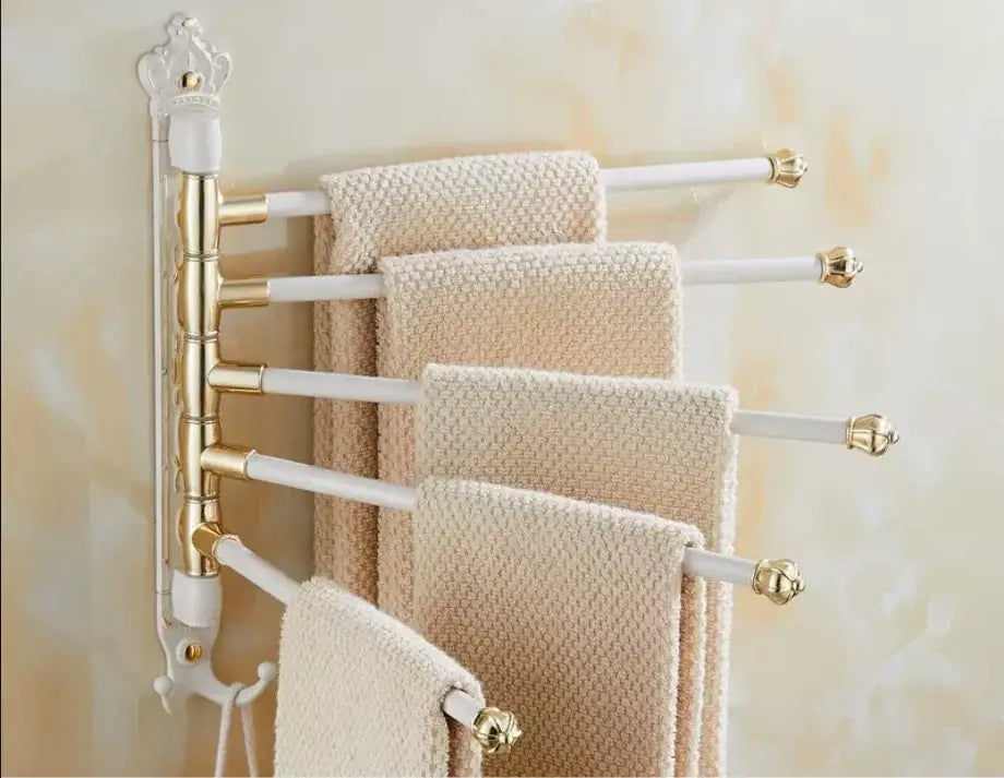 Elegant white and gold antique carved swivel towel rack with ornate crown top holding cream textured towels