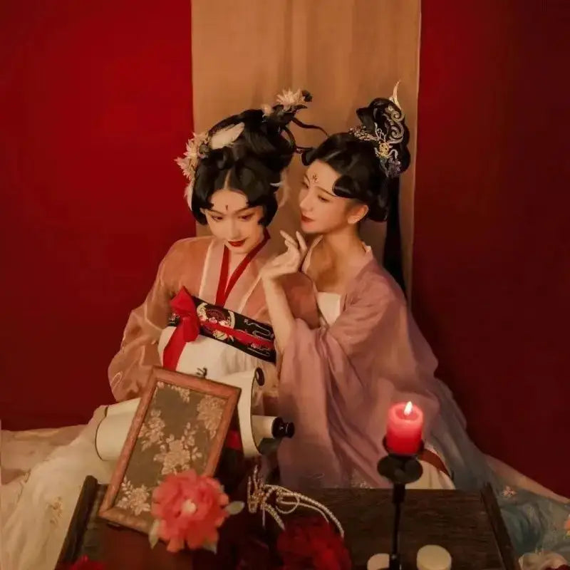 Two women in traditional hanfu beside a solid wood antique chinese style table ideal for hanfu shoots and tea time