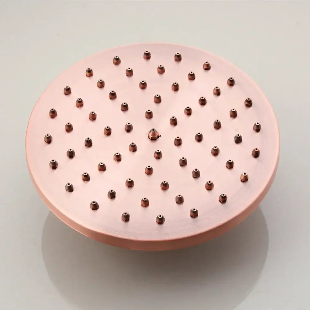Rose gold copper showerhead with evenly spaced rounded nozzles in DecorBites antique copper shower set with hand shower