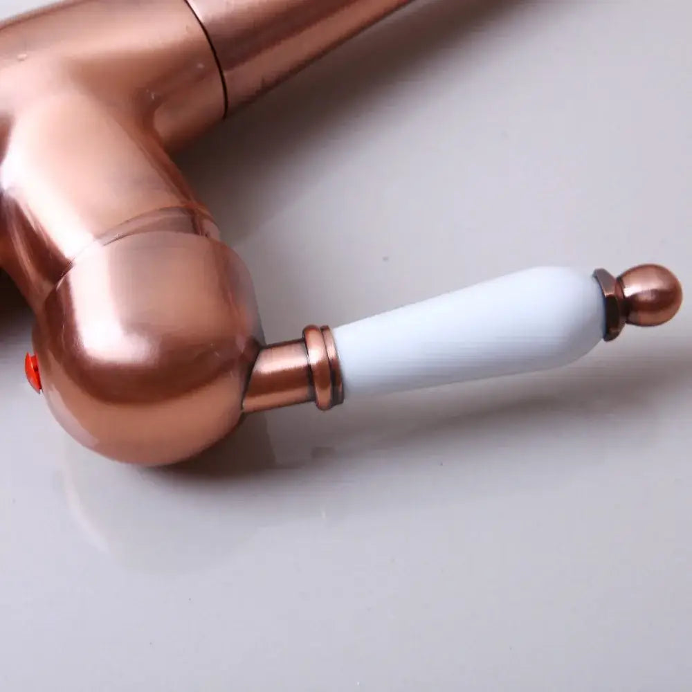 DecorBites antique copper basin mixer tap with copper finish, white ceramic handle, and polished brass accents
