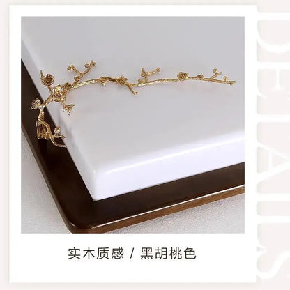 Golden metal branch-shaped hair accessory with blossoms and leaves paired with decorbites antique copper led ceiling light