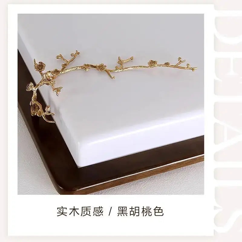 Golden metal branch-shaped hair accessory with blossoms and leaves paired with decorbites antique copper led ceiling light
