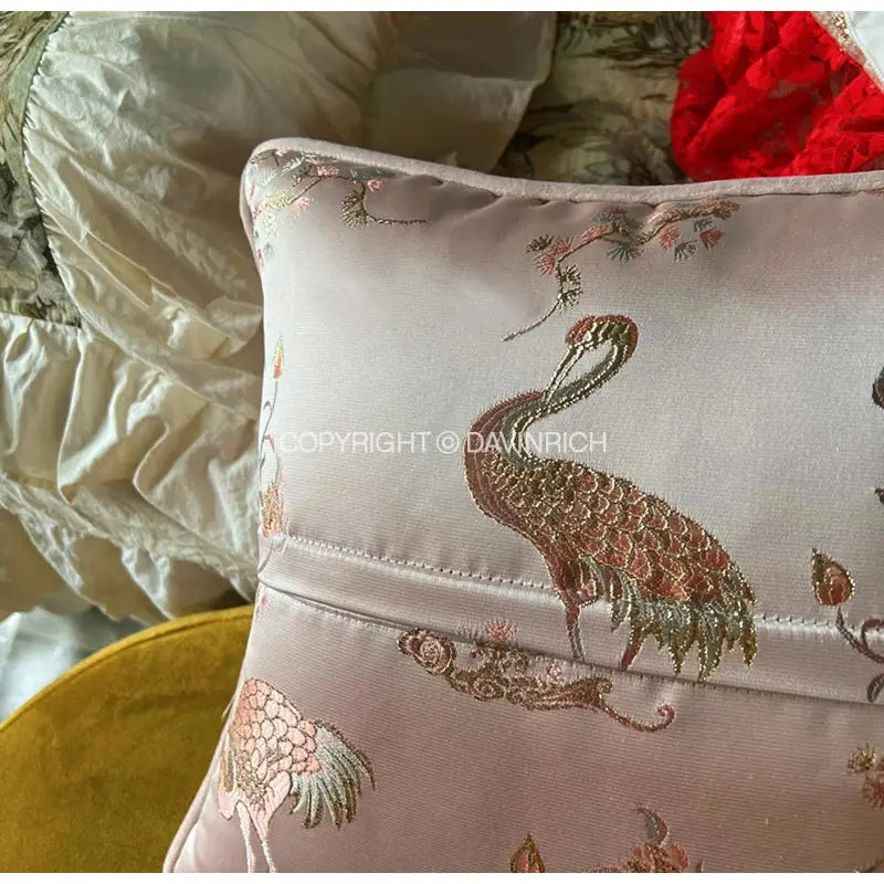 Soft pink satin pillow case with antique crane floral jacquard embroidery and gold brown detailed feathers by decorbites