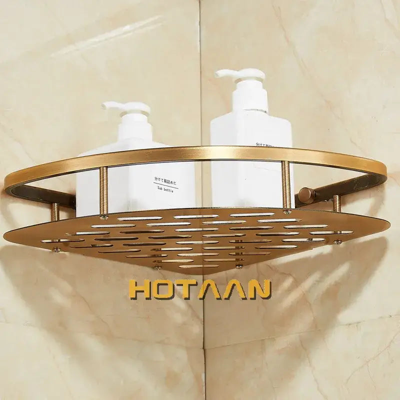Gold-toned metal corner shower caddy with perforated design and vertical bars in antique finish aluminum shower style
