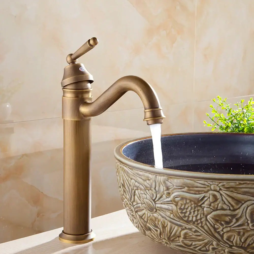Decorbites antique finish brass basin faucet with single handle curved spout and textured finish for bathroom vanity