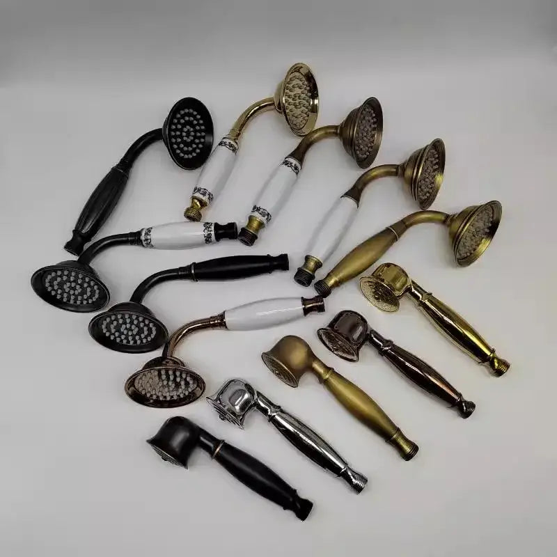 A collection of elegant antique gold handheld shower heads with brass and ceramic handles featuring ornate detailing