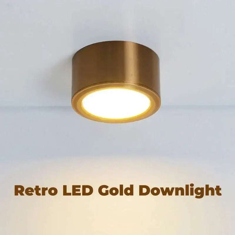 Retro decorbites antique gold led ceiling downlight with cylindrical brass housing and warm circular illumination