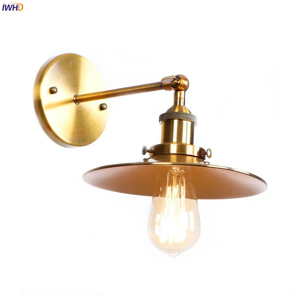 Brass-finished decorbites antique gold rustic wall lamp with circular backplate and wide dome shade housing filament bulb