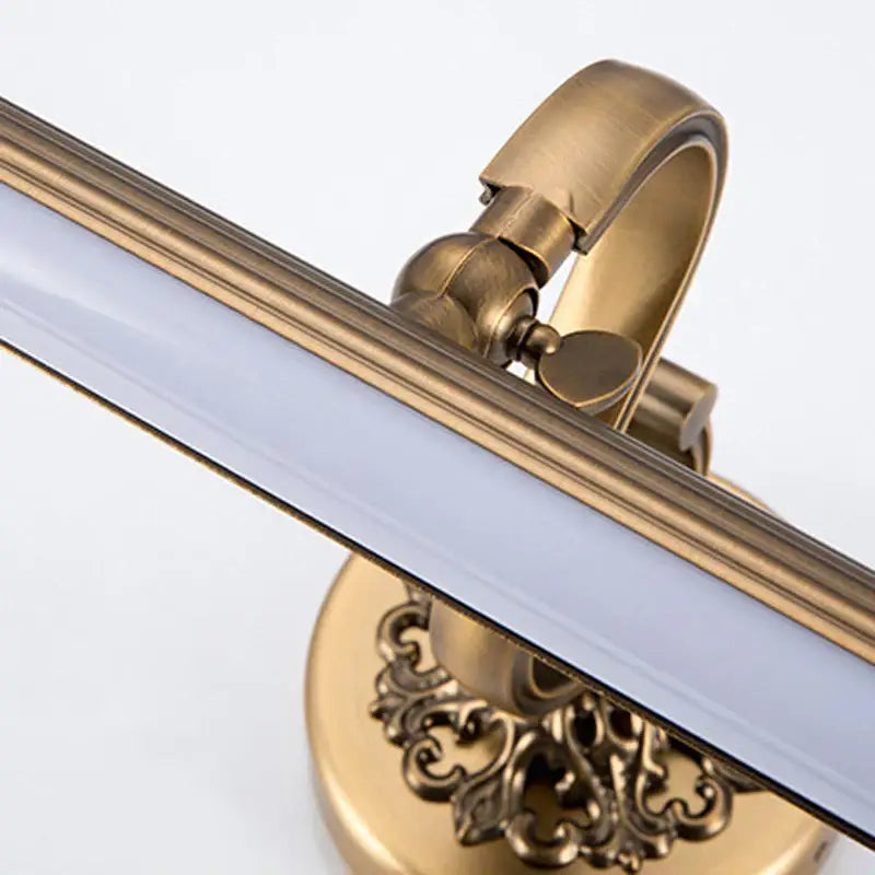 DecorBites antique golden bronze mirror LED wall light with brass finish, frosted glass tube, and ornate scrollwork base