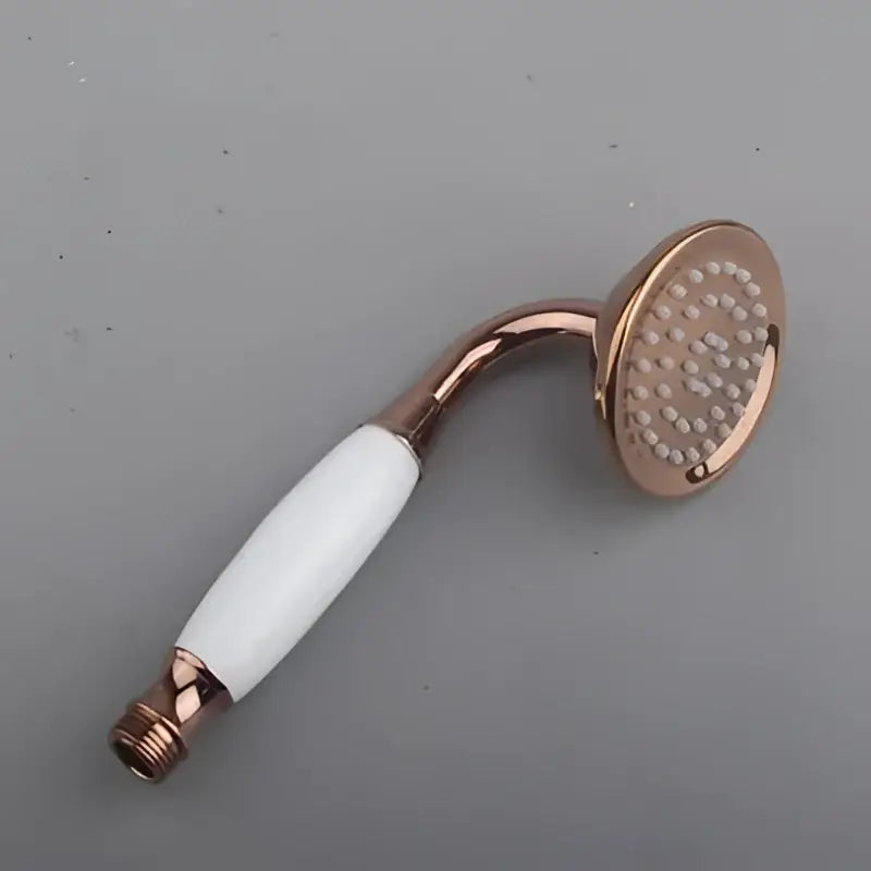 Rose gold shower head with white ceramic handle and multiple nozzles paired with DecorBites shower head holder