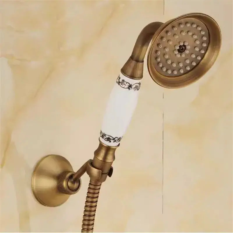 Decorbites antique handheld shower head with brass finish and white ceramic handle decorated with black floral patterns