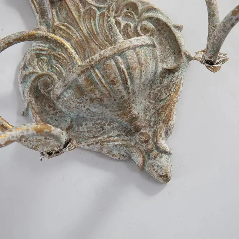 Decorbites antique iron double wall lamp with brass antique-style leafy scrollwork and distressed greenish patina