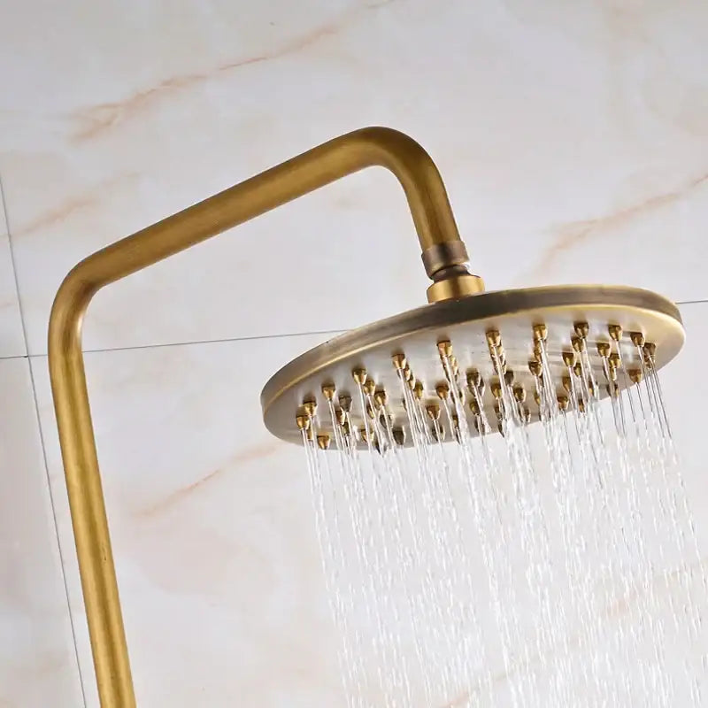 Brass-finished round 8 inch rainfall showerhead with curved arm in DecorBites™ antique shower mixer tap set