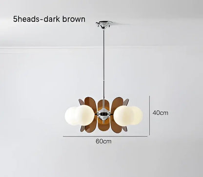 Dark brown wooden decorbites antique style chandelier with five spherical white glass shades for living room use