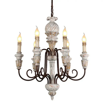 Decorbites antique white wooden chandelier with distressed white and gold finish and ornate wrought iron arms holding candle bulbs