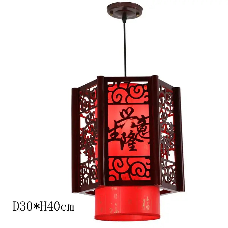 Red lantern-style decorbites antique wood pendant light with carved patterns and glowing red panels for dining room lighting
