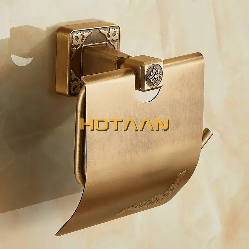 Antiqued brass toilet paper holder by DecorBites with ornate floral embossing and square wall-mounted bracket